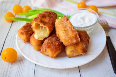 Fried suluguni cheese in a pan in breadcrumbs