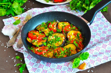 Fried eggplant slices in a pan with garlic