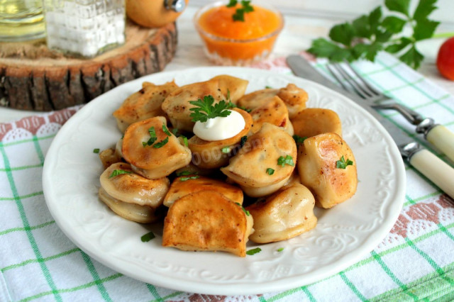 Frozen dumplings fried in a frying pan