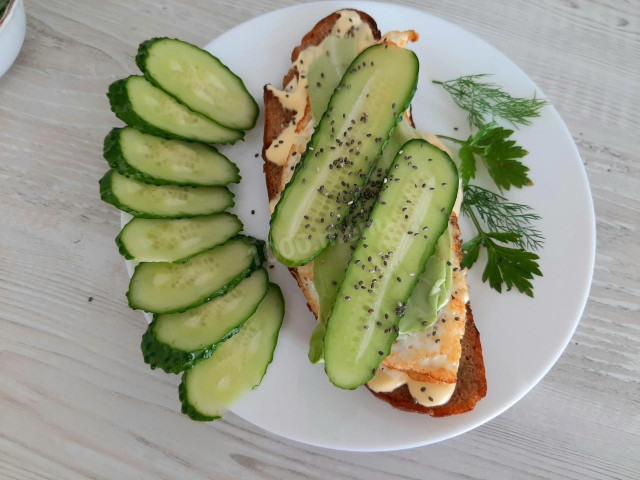 Hot egg sandwich, mayonnaise and fresh cucumber