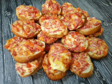 Incomparable mini pizzas on a loaf in the oven