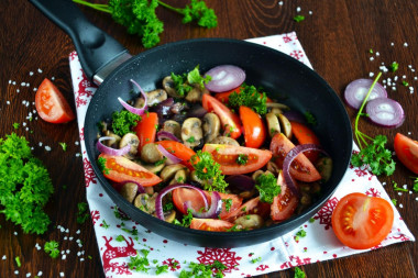 Mushrooms with tomatoes fried in a pan