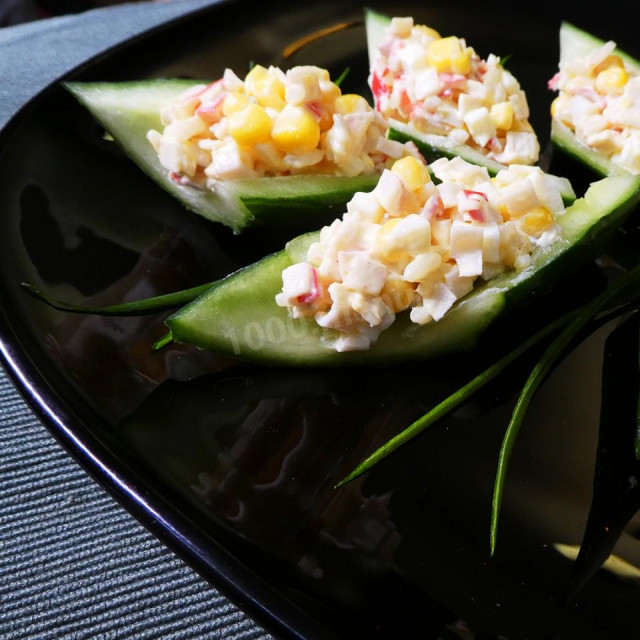 Salad crab sticks rice corn in cucumber boats