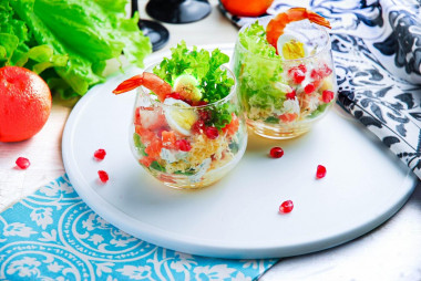 Salad in cream bowls with shrimp, portioned festive