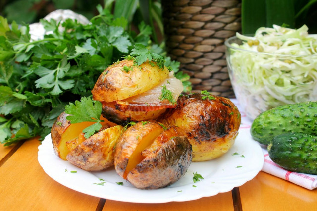 Potatoes with bacon in foil on coals