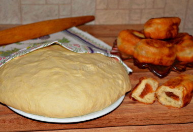 Dough for pies in a frying pan on water