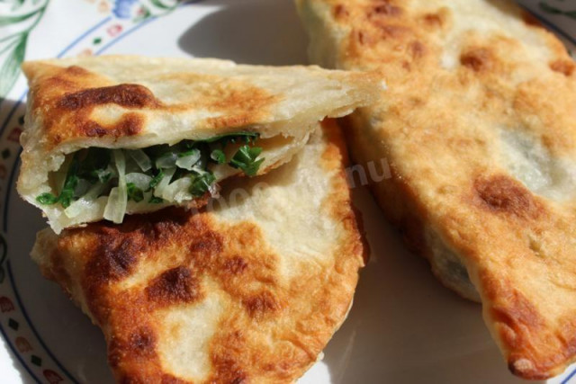 Cutabs with spinach and herbs in a frying pan