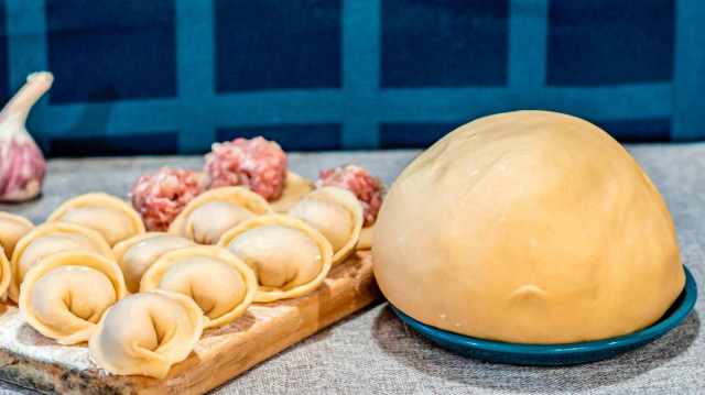 Custard dough for dumplings in boiling water with egg