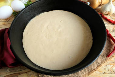 Pizza dough in a frying pan