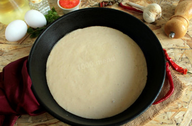 Pizza dough in a frying pan