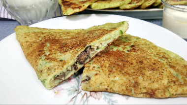 Zucchini chebureks stuffed with mushrooms and cheese