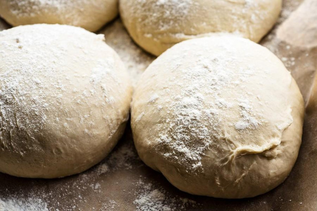 Pizza dough with olive oil in milk