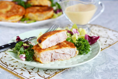 Hake medallions in a frying pan