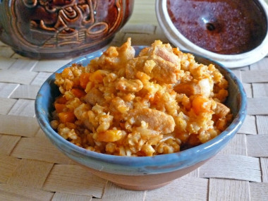 Porridge with meat in a pot in the oven pearl barley