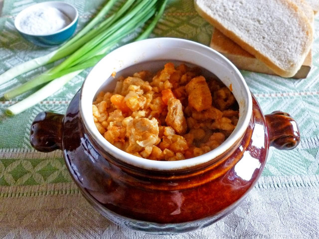 Porridge with meat in a pot in the oven pearl barley