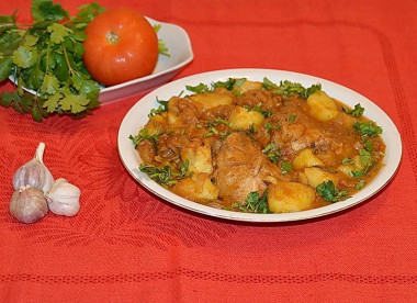 Chicken Chakhokhbili with potatoes in a frying pan