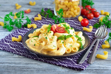 Pasta with sour cream and cheese in a frying pan