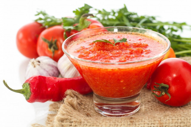 Bulgarian and hot pepper adjika with tomatoes for winter