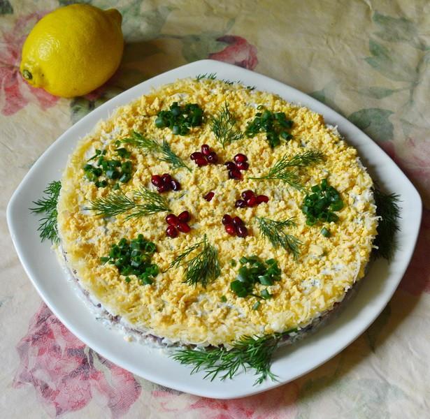 Salad with cod liver layered with cheese and rice