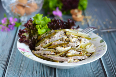 Salad with tongue and pickled cucumbers