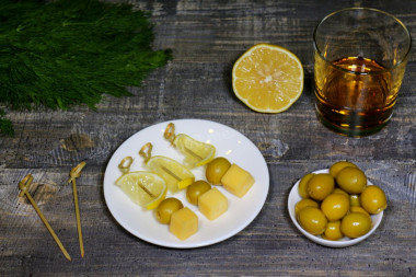 Canapes with olives and cheese on skewers