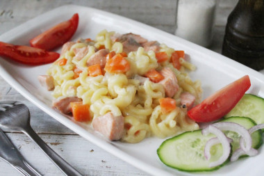 Pasta with pink salmon, onion and carrot in sauce