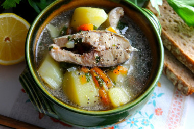 Trout soup in a cauldron over a campfire