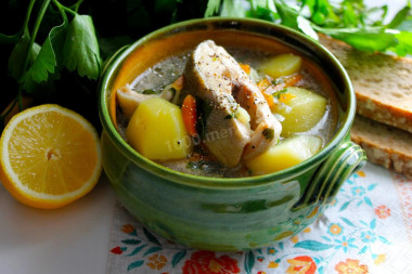 Trout soup in a cauldron over a campfire