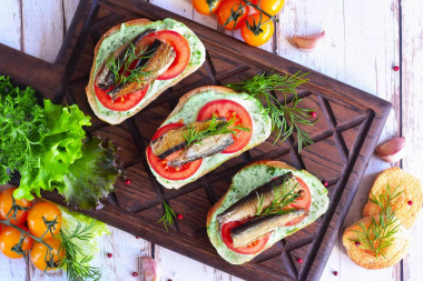 Sandwiches with sprats, mayonnaise and garlic on a loaf