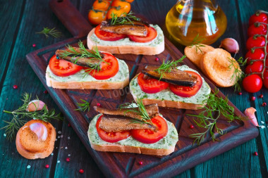 Sandwiches with sprats, mayonnaise and garlic on a loaf