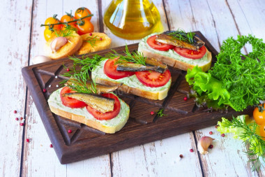 Sandwiches with sprats, mayonnaise and garlic on a loaf