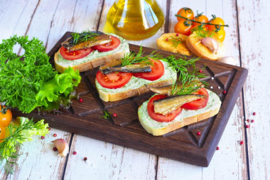 Sandwiches with sprats, mayonnaise and garlic on a loaf