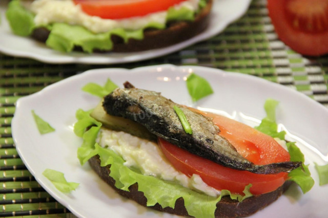 Garlic black bread croutons in a pan with sprats