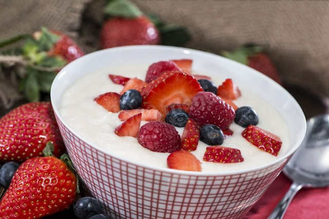 Semolina porridge with berries on water for a child