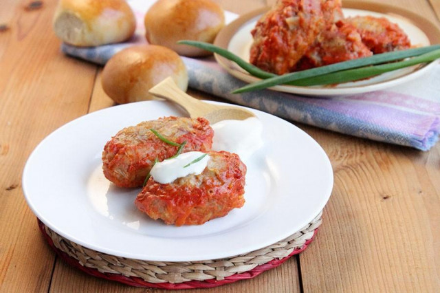 Lazy cabbage rolls with minced meat in tomato and sour cream sauce in the oven