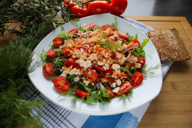 Simple salad of cherry tomatoes and cheese rucolla