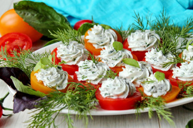 Appetizer of red and yellow tomatoes with cheese and garlic