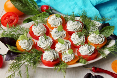 Appetizer of red and yellow tomatoes with cheese and garlic