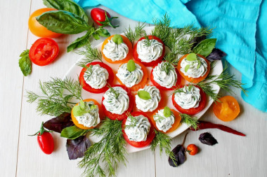 Appetizer of red and yellow tomatoes with cheese and garlic