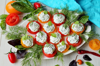 Appetizer of red and yellow tomatoes with cheese and garlic