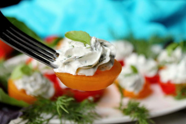 Appetizer of red and yellow tomatoes with cheese and garlic