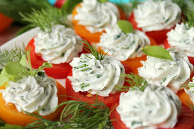 Appetizer of red and yellow tomatoes with cheese and garlic