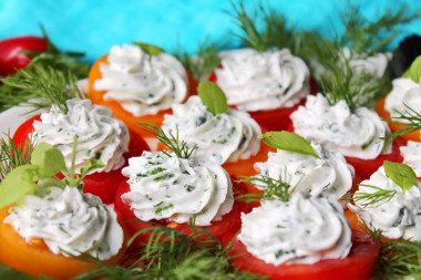 Appetizer of red and yellow tomatoes with cheese and garlic