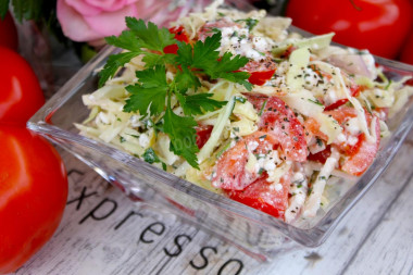 Salad of young cabbage with tomatoes and cottage cheese.