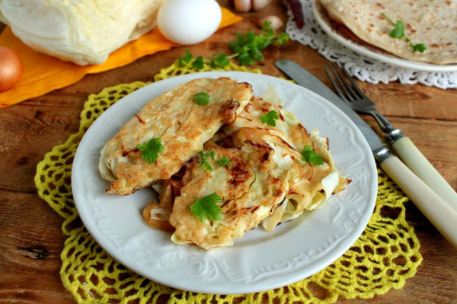 White cabbage in batter in a frying pan