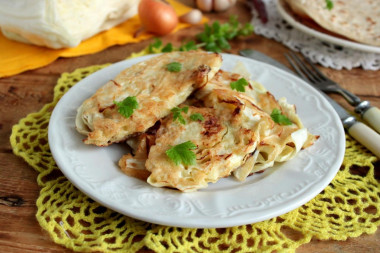 White cabbage in batter in a frying pan