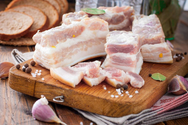 Bacon boiled in a glass jar with bay leaf