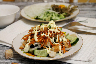 Salad with Korean carrots, smoked sausage and cucumbers