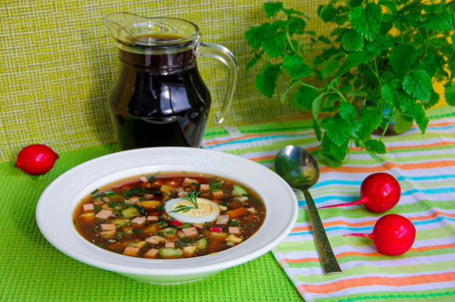 Okroshka with green peas on kvass with sausage