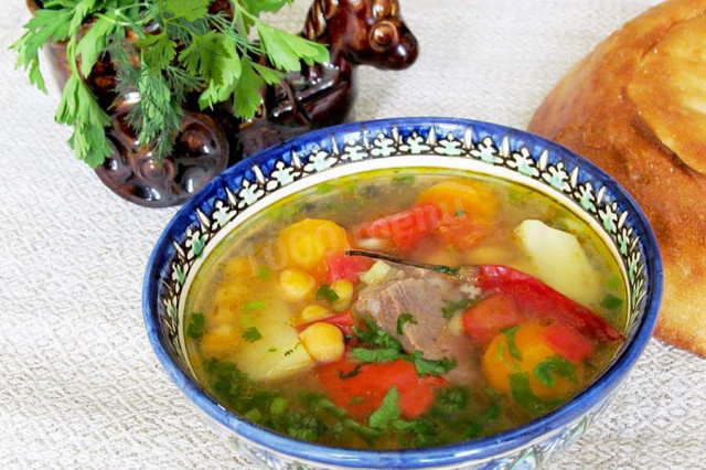 Lamb shurpa with chickpeas and chili pepper in a cauldron